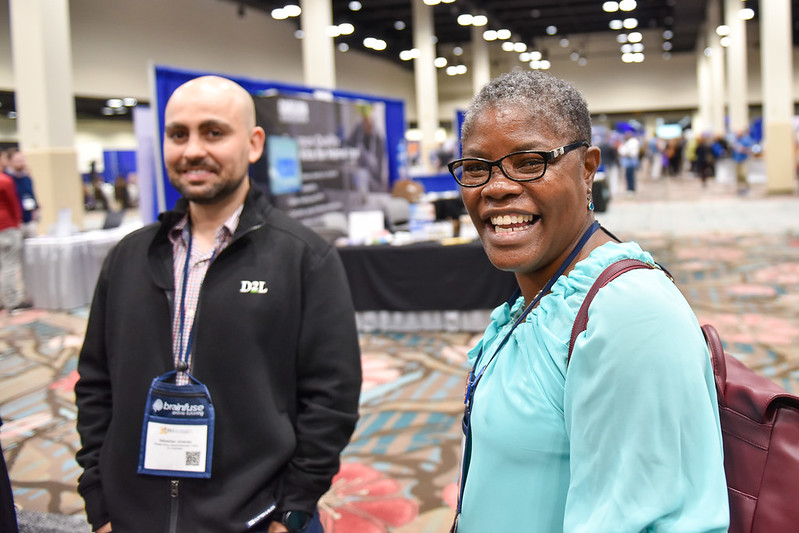 Two OLC conference attendees smile for a photo